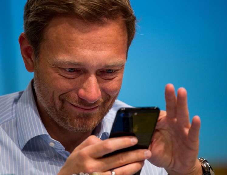 Christian Lindner widmet seine volle Aufmerksamkeit seinem Smartphone