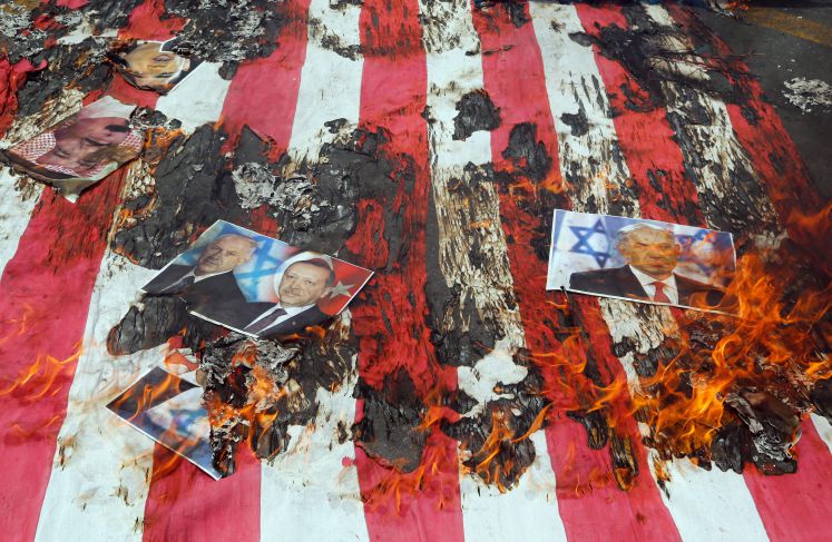 Iranians burn a US flag and portrait of Israeli Prime Minister Benjamin Netanyahu (R) and Turkish President Recep Tayyip Erdogan (2-R) during a rally marking Qods Day (Jerusalem Day), in support of Palestinian resistance against Israeli occupation, in Tehran, Iran, 01 July 2016. 