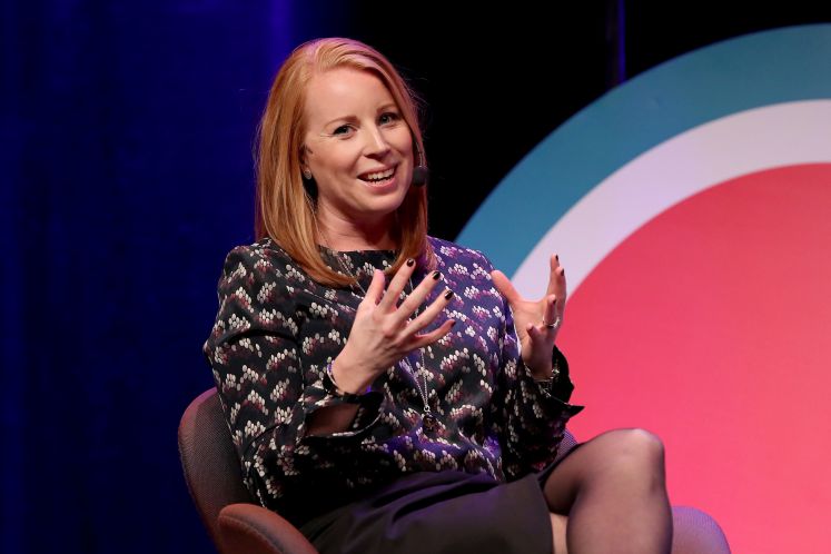 Annie Lööf sitzt auf der Bühne während eines Interviews und lächelt