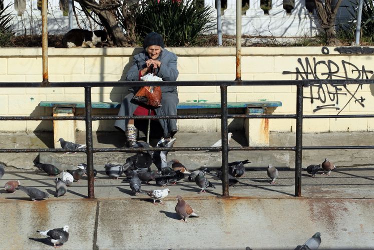 Alte Frau auf einer Bank in Sotschi 