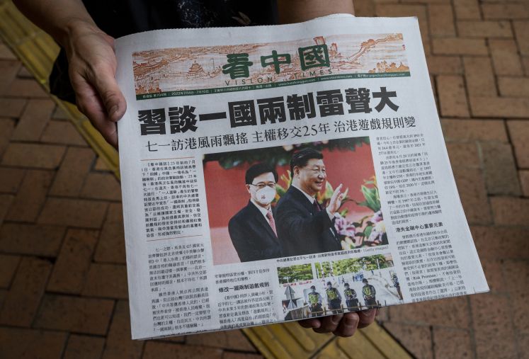 Eine Frau in Hongkong verteilt die Vision Times China