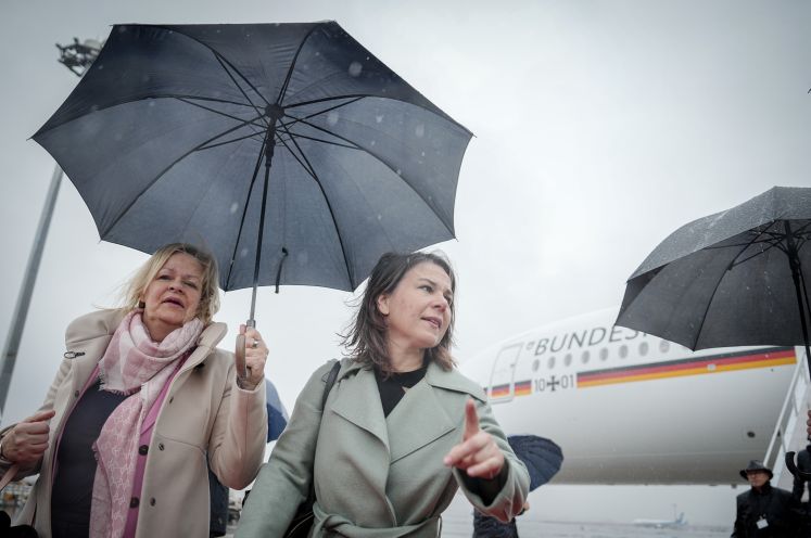 Nancy Faeser und Annalena Baerbock mit Regenschirm am Flughafen Tokio