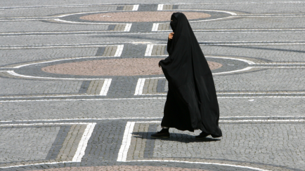 Eine Frau in einer Burka geht über den Odeonsplatz in München