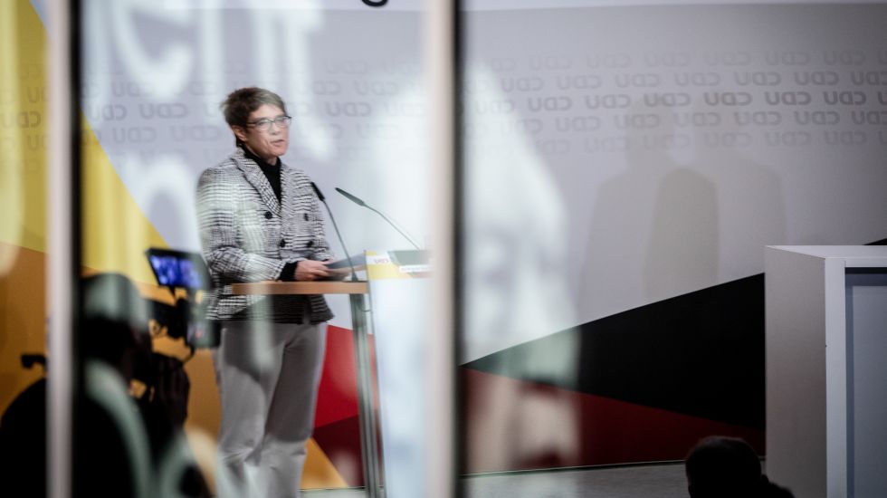 11.02.2019, Berlin: Annegret Kramp-Karrenbauer, CDU-Bundesvorsitzende, spiegelt sich bei ihrer Rede zu den Ergebnissen zum Abschluss des "Werkstatt-Gesprächs" der CDU zu den Themen Migration, Sicherheit und Integration in einer Glasscheibe mit einem Bild von Konrad Adenauer.